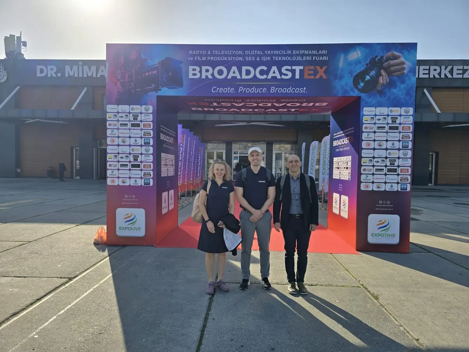 Three members of the Veset team in front of the BroadcastEx 2026 entrance in Istanbul